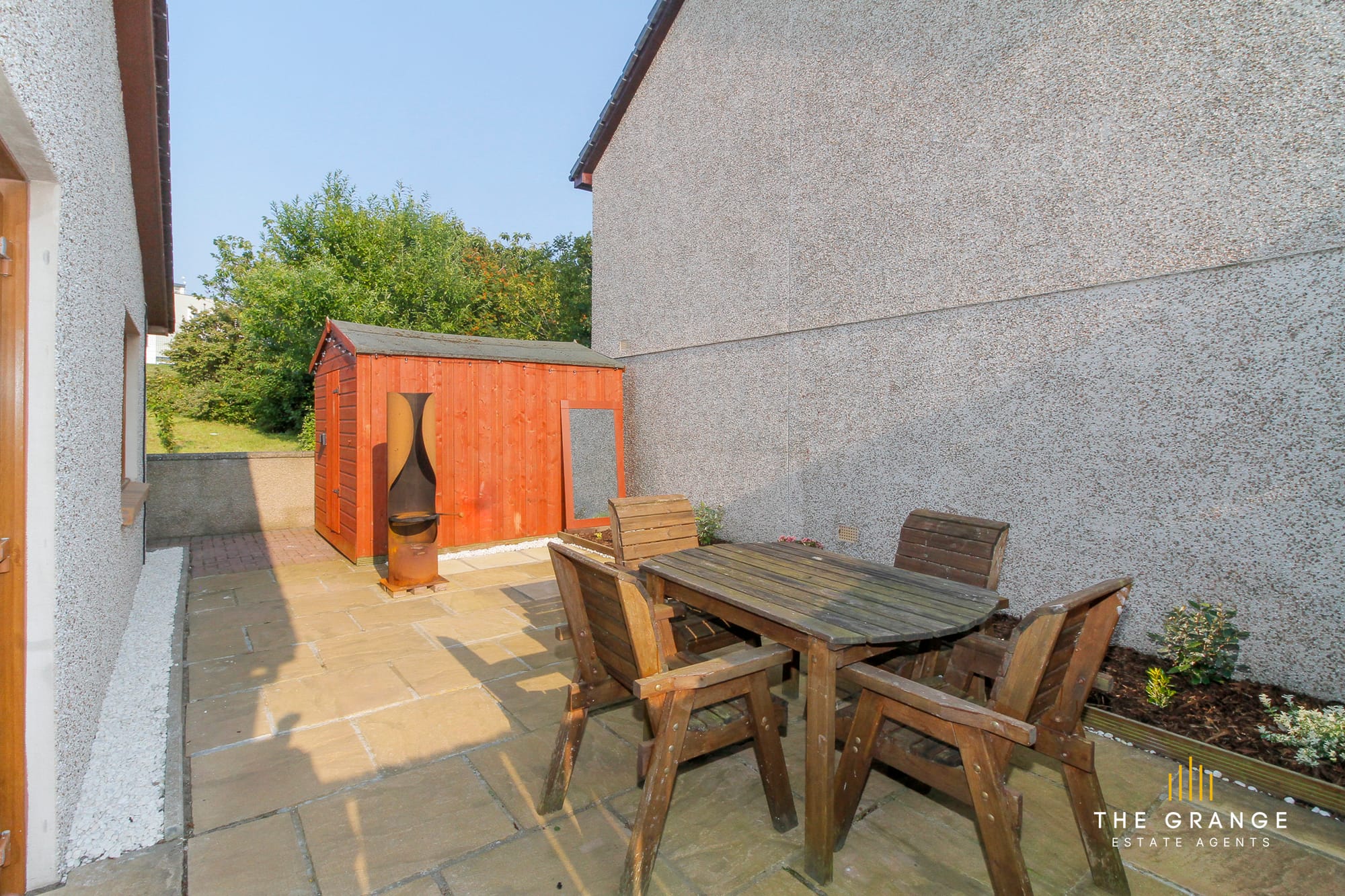 Outdoor lounge and barbecue area, with patio table and fire pit
