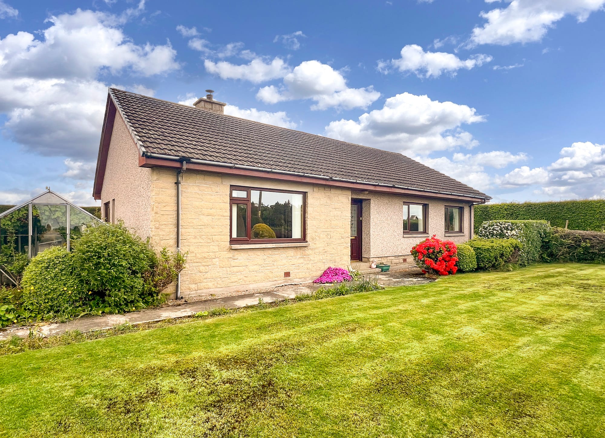 The bungalow and surrounding fields