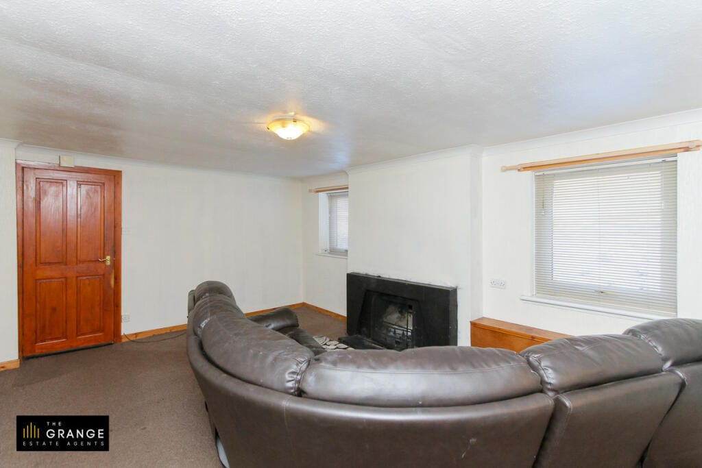 Lounge with corner sofa and fireplace