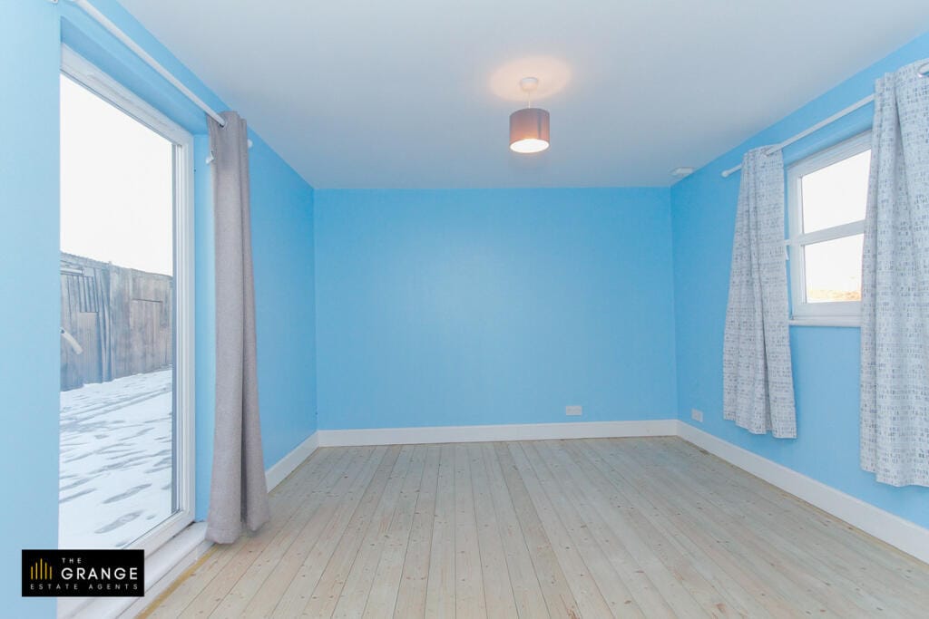 Blue bedroom with patio door