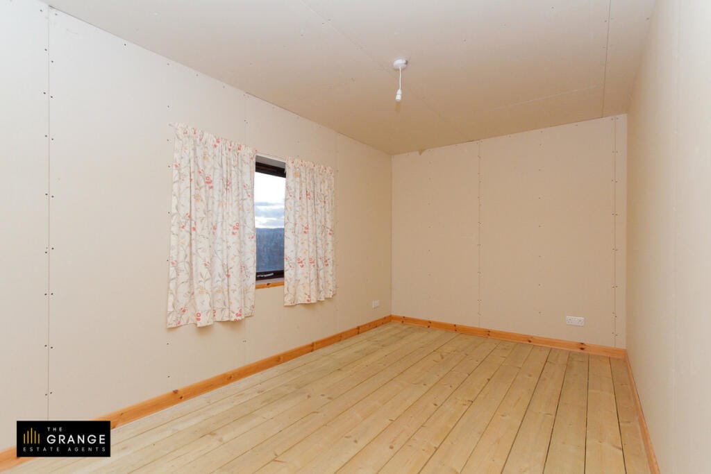 Further bedroom with floral curtains