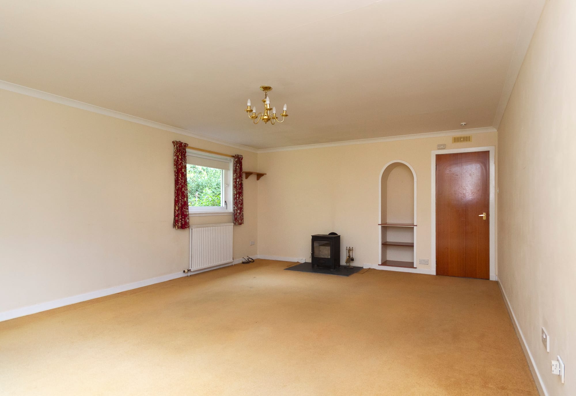 The lounge, with its stove and arched shelf recess