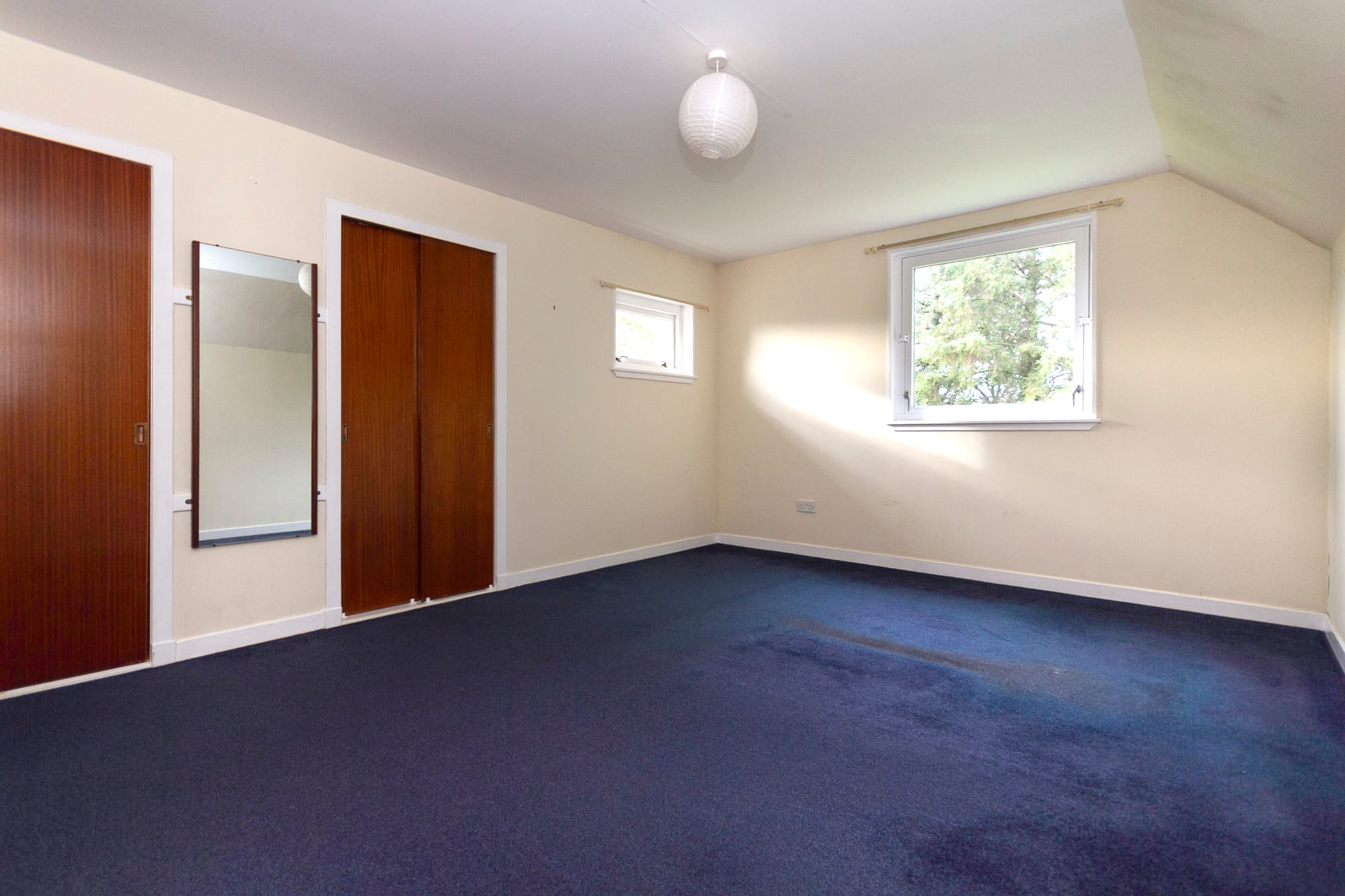 A bedroom with fitted wardrobes