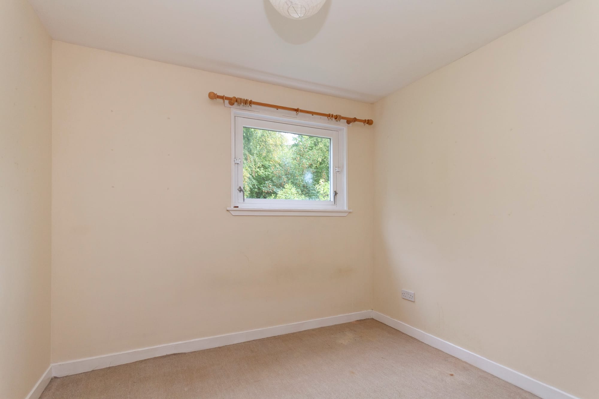 A bedroom looking out to the trees