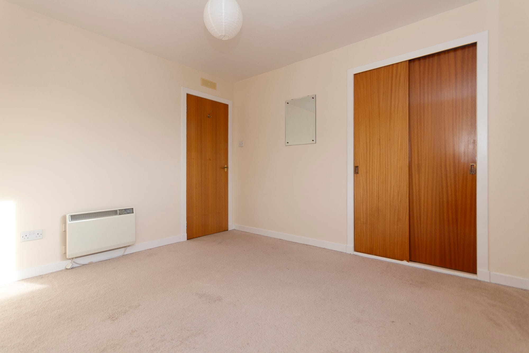 A bedroom with fitted wardrobes