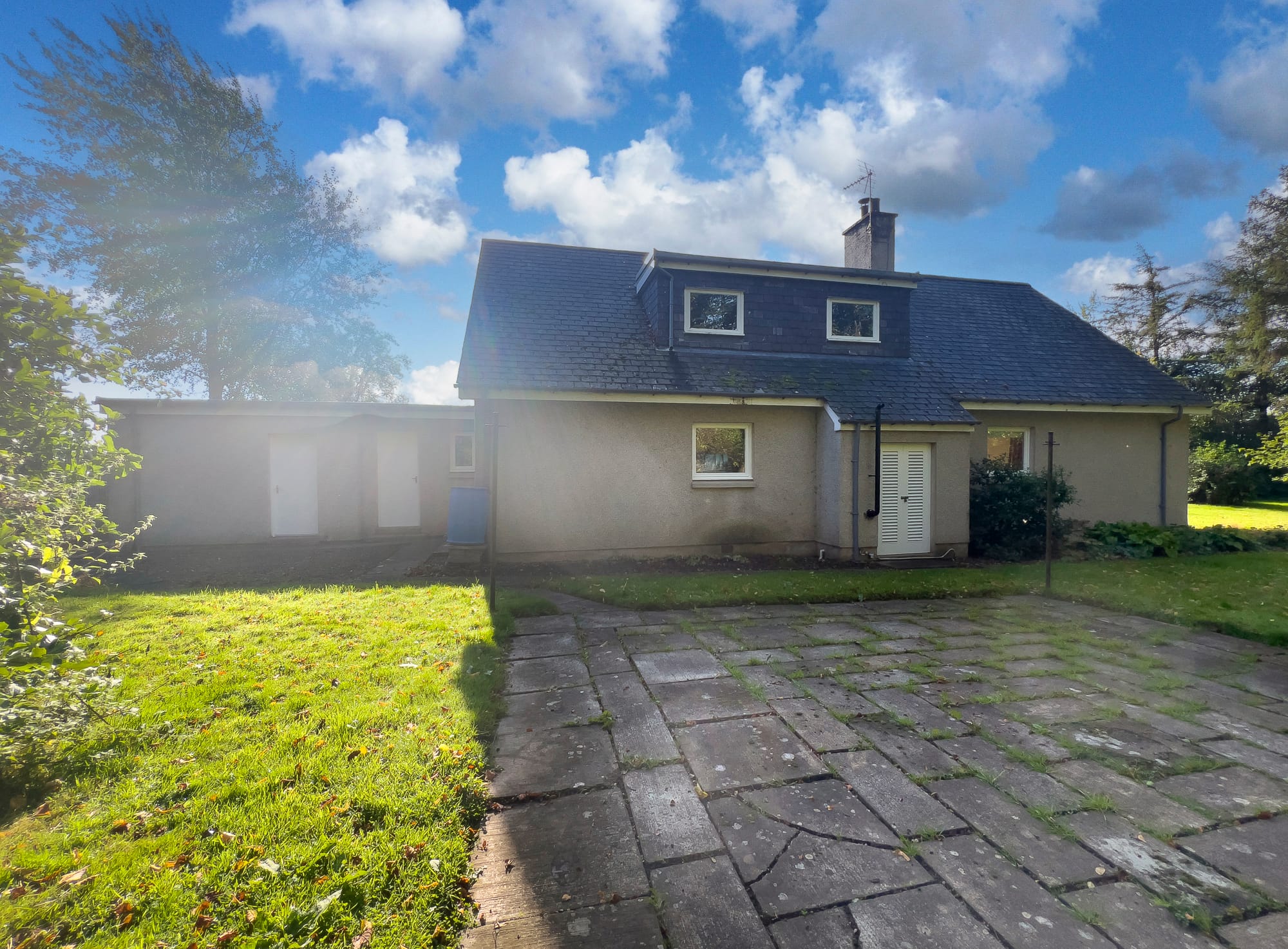 The rear of the house and the paved patio