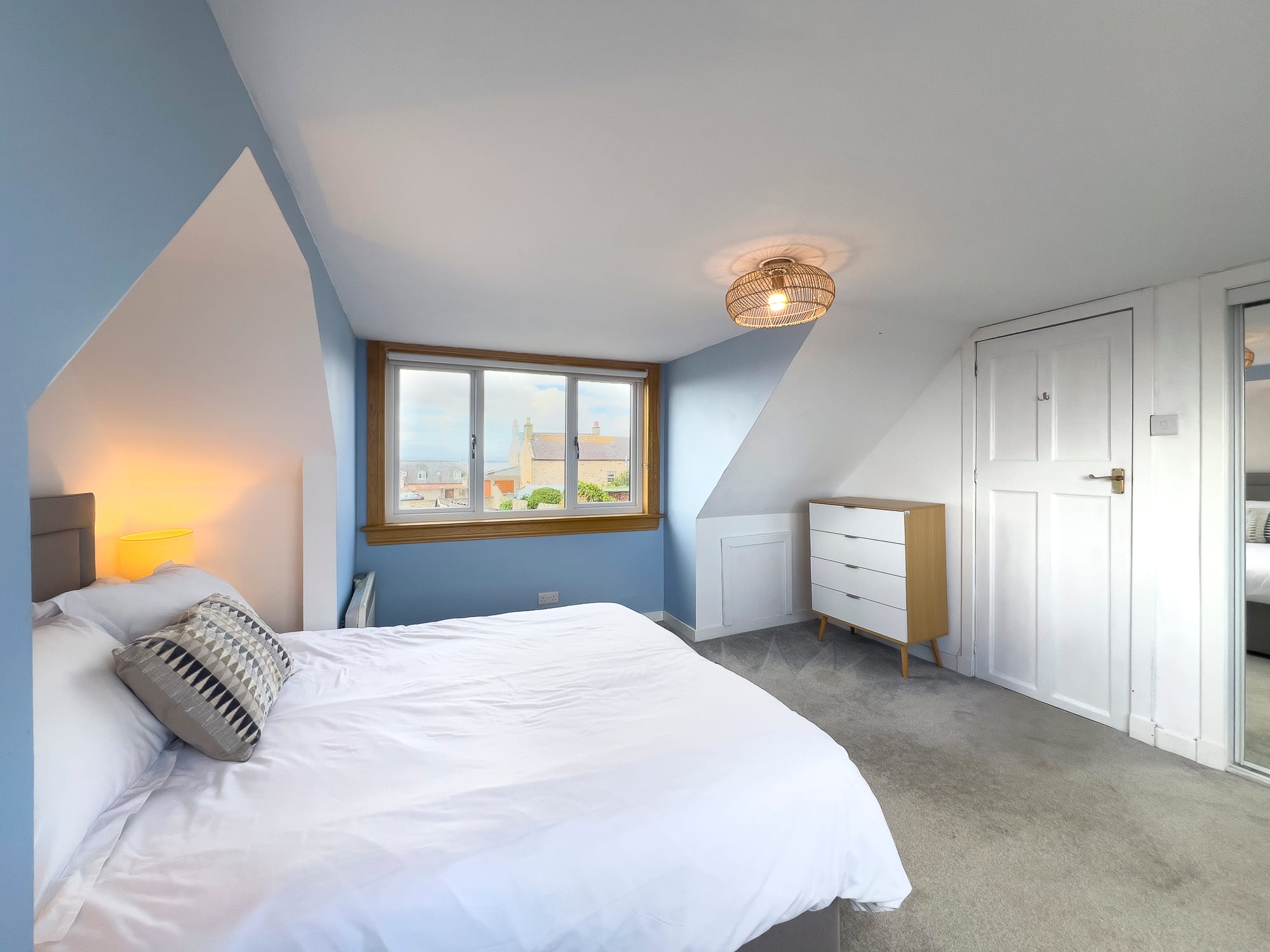 Double bedroom with a dormer window looking out to sea — Dunbar Street, Burghead