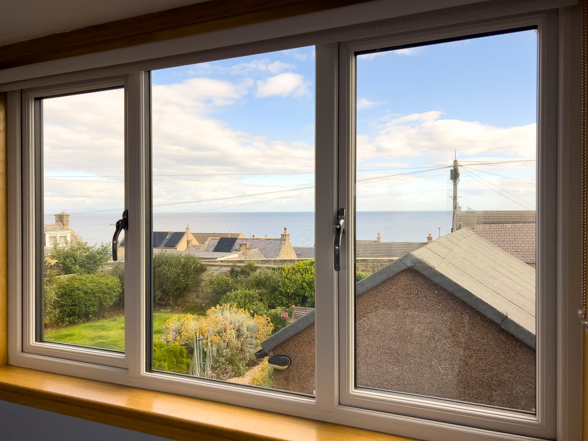 Rooftops and the sea from a bedroom window — Dunbar Street, Burghead