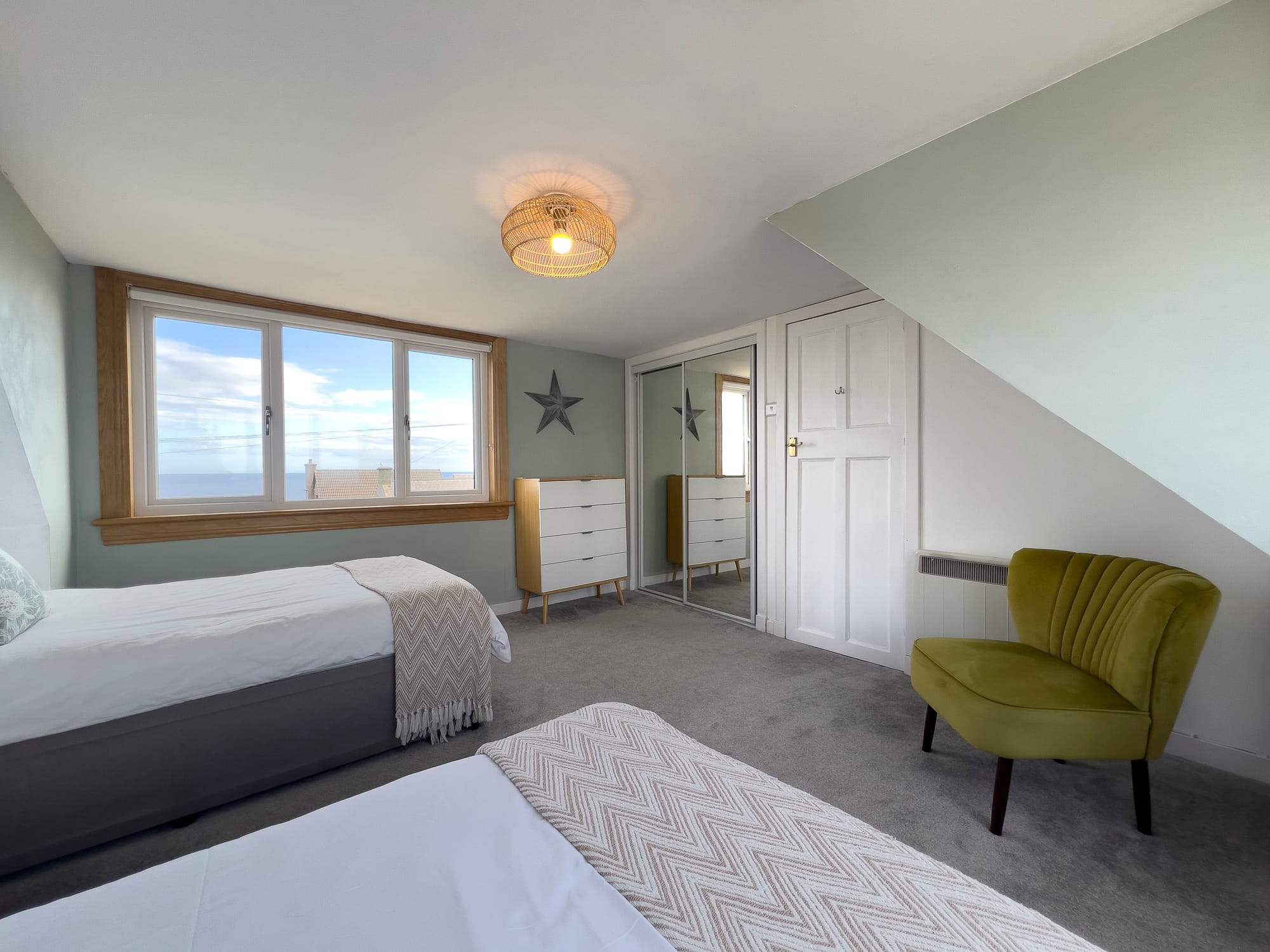 Twin bedroom with an armchair — Dunbar Street, Burghead