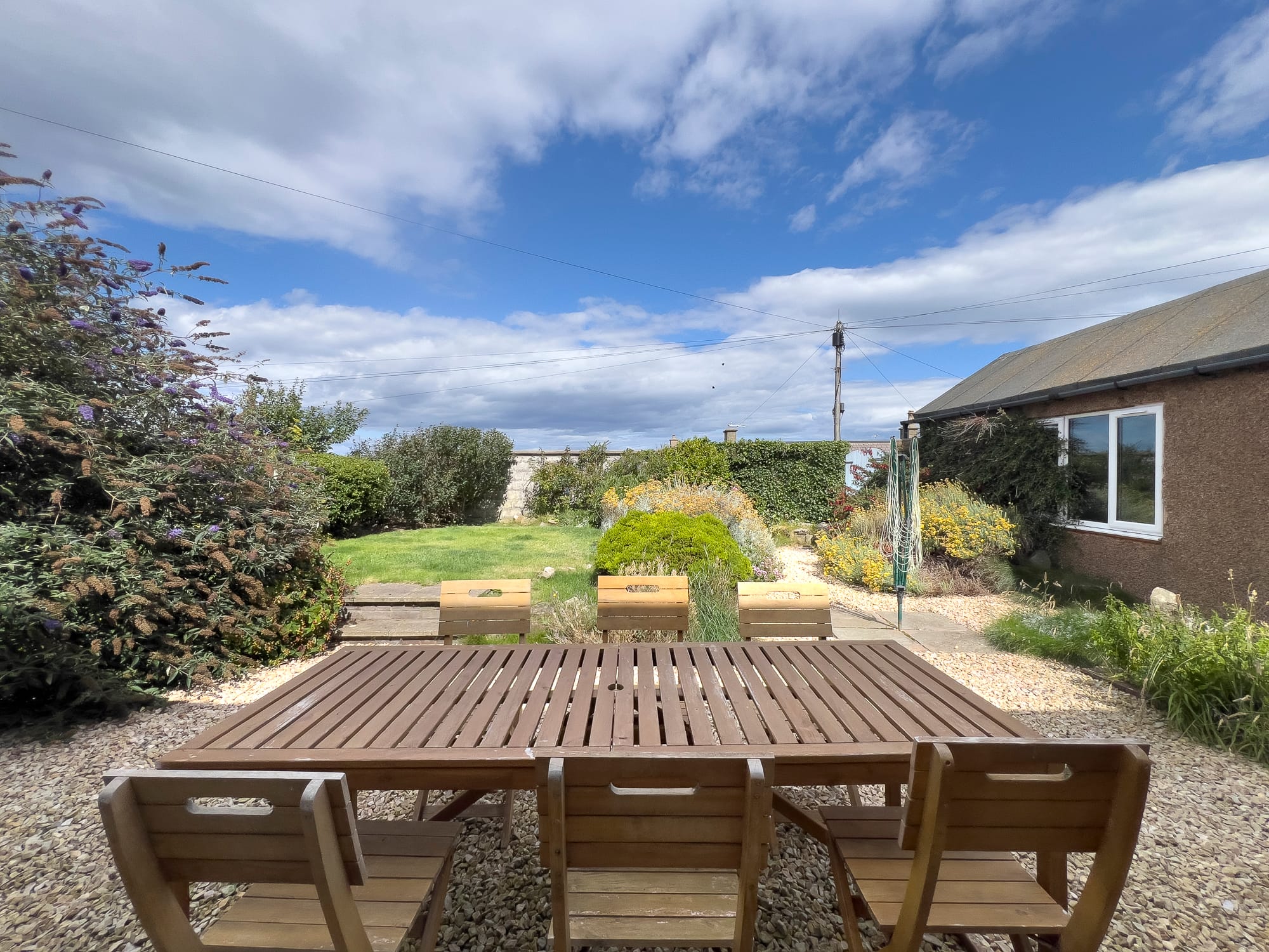 Garden table and seating on the gravel terrace — Dunbar Street, Burghead