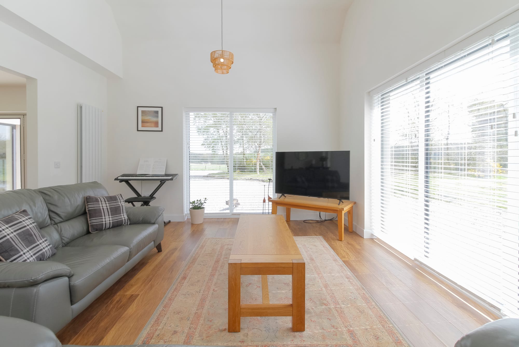 Living and dining space with vaulted ceiling