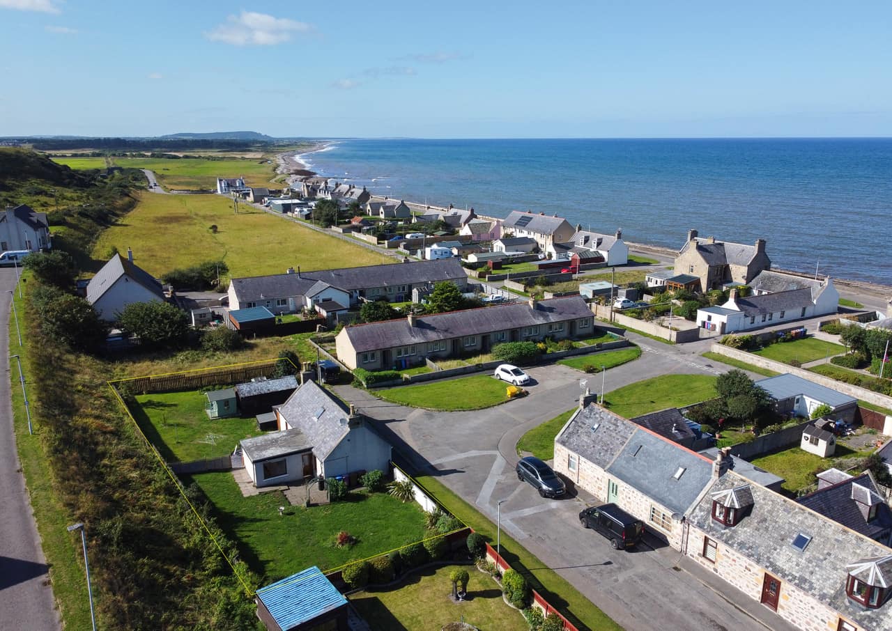 The house and the coastline from the air