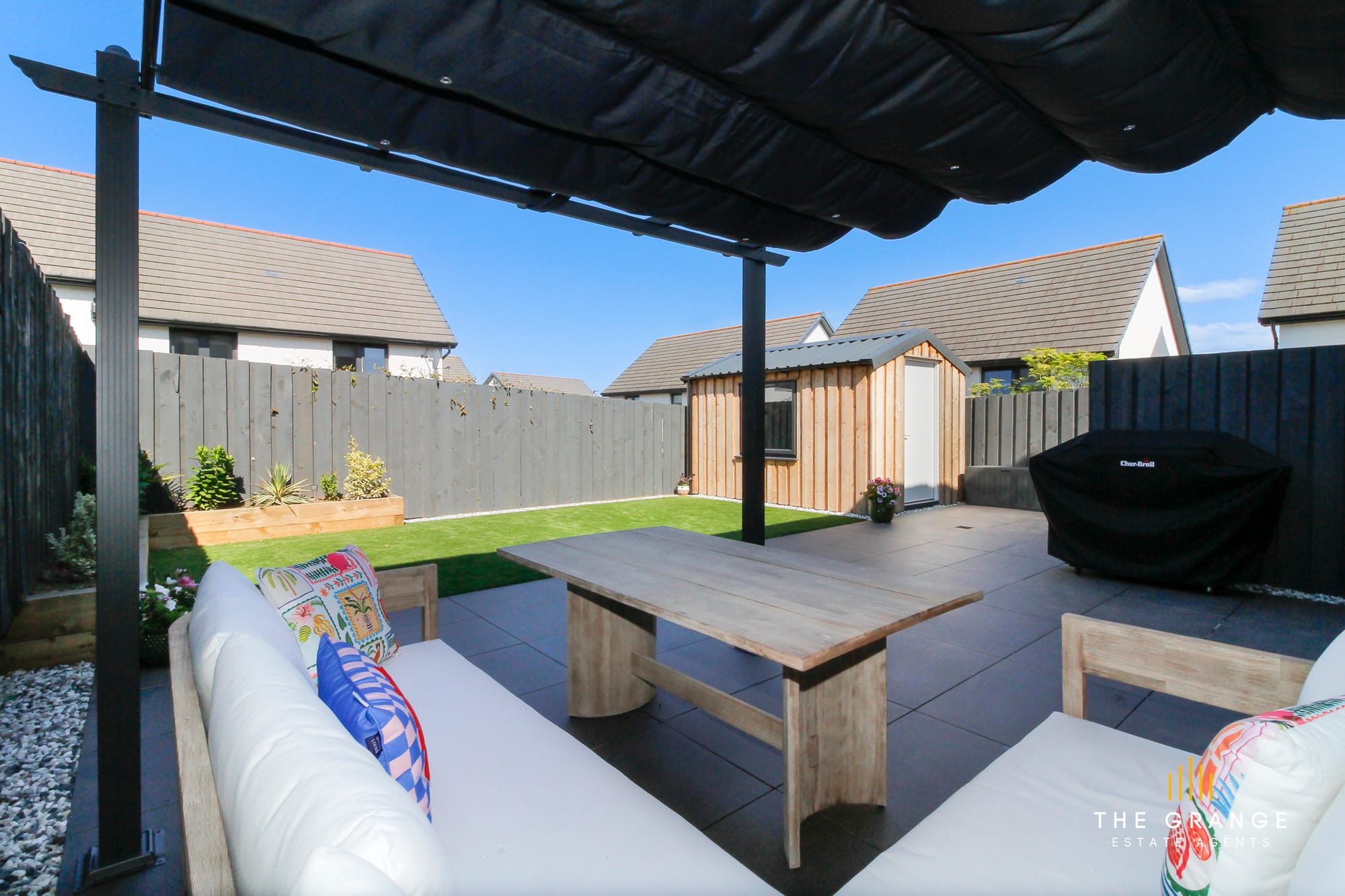 The garden from the pergola, with lawn and garden room