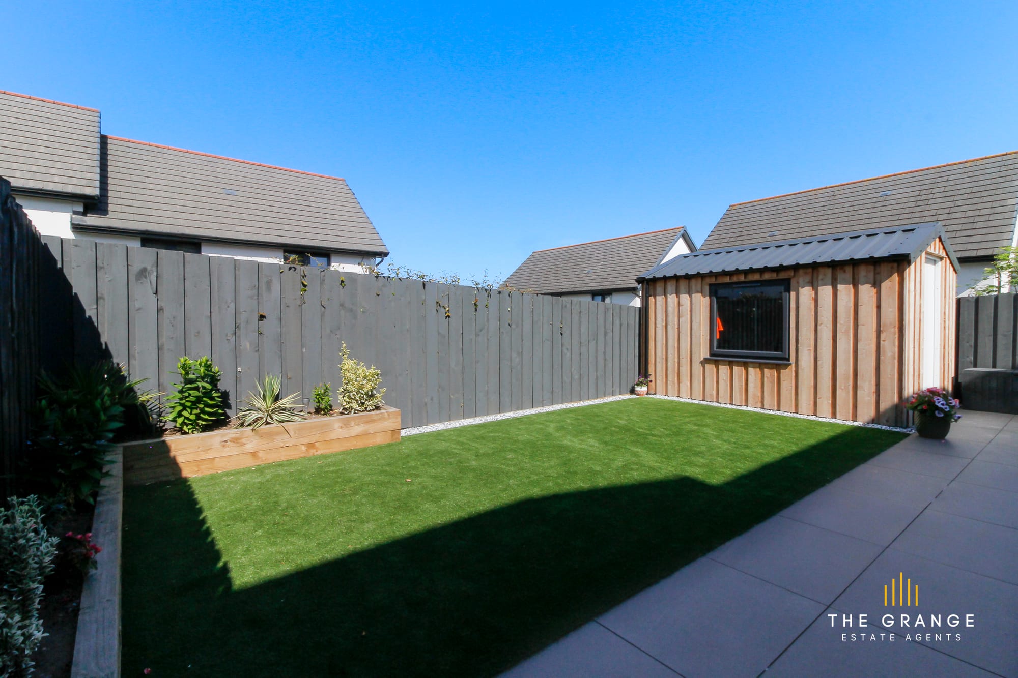 The lawn, planters and garden room