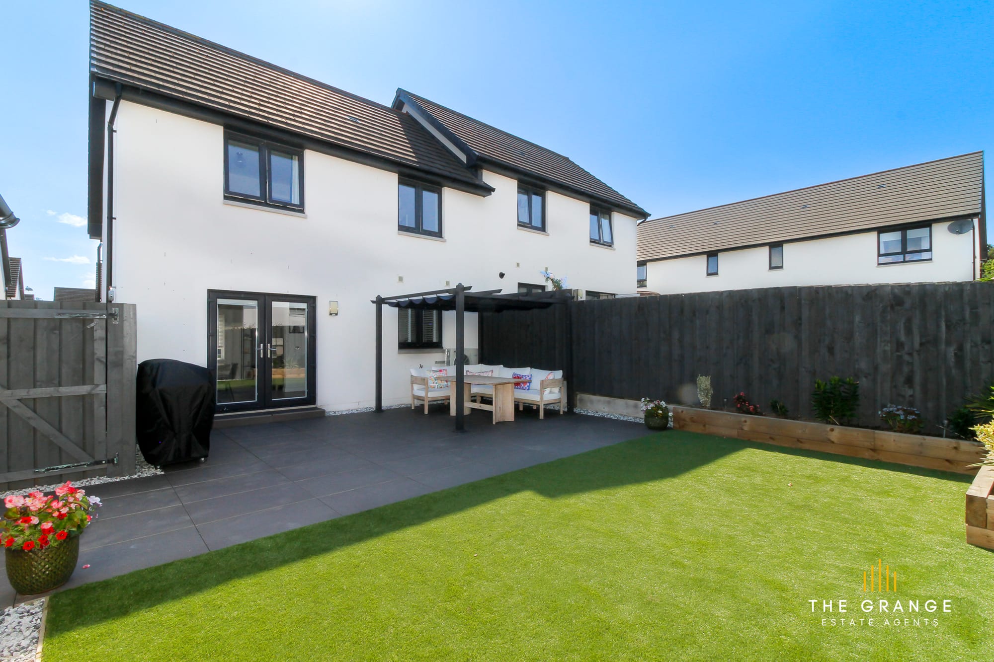 The rear garden, patio and house
