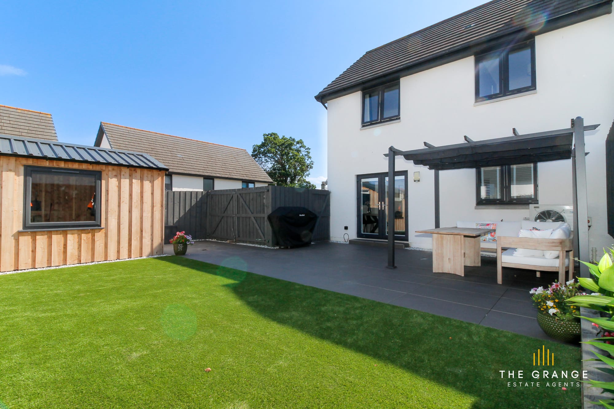 The rear of the house, with patio and pergola seating